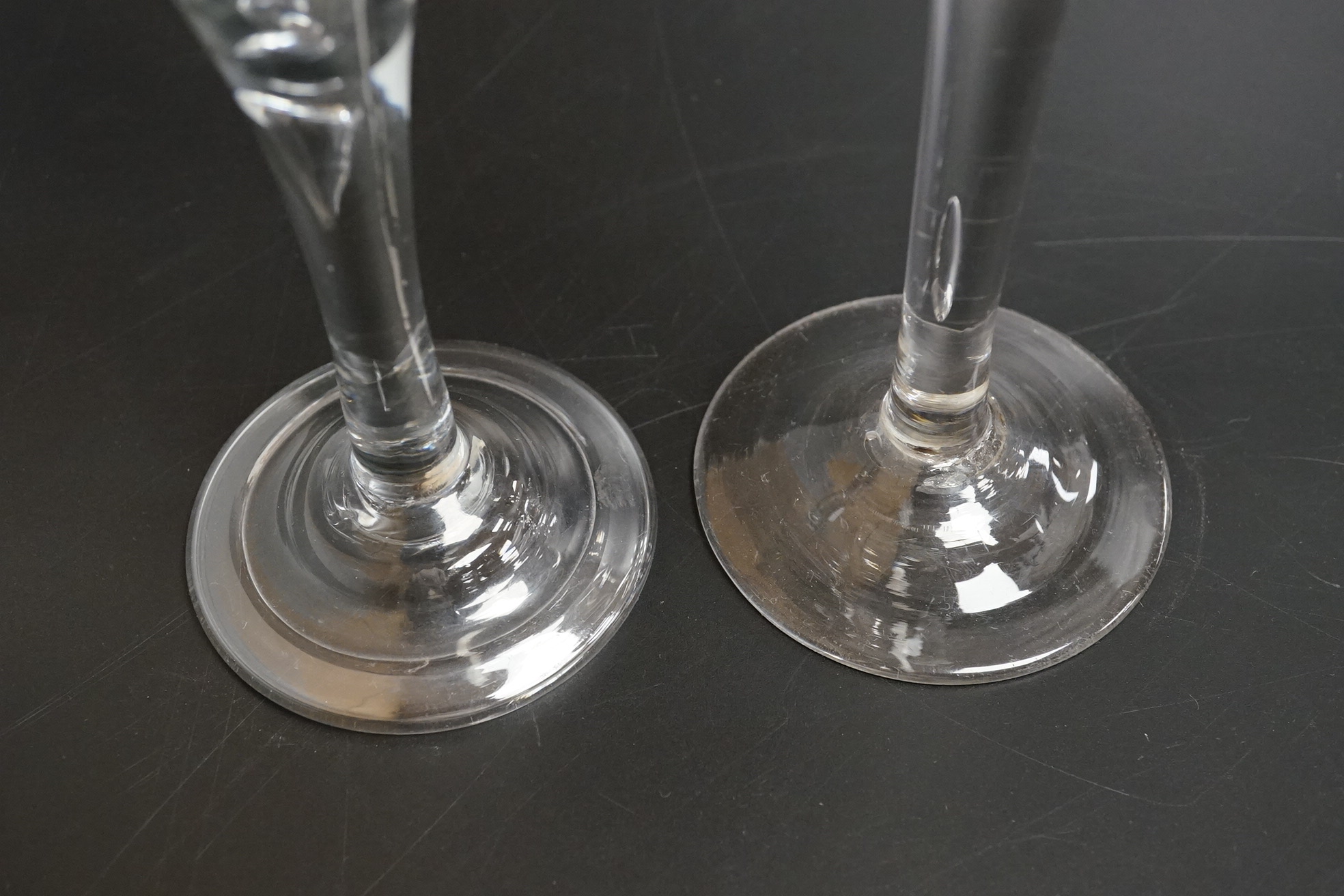 Two 18th century glass wine flutes, one with folded foot, tallest 16cm high